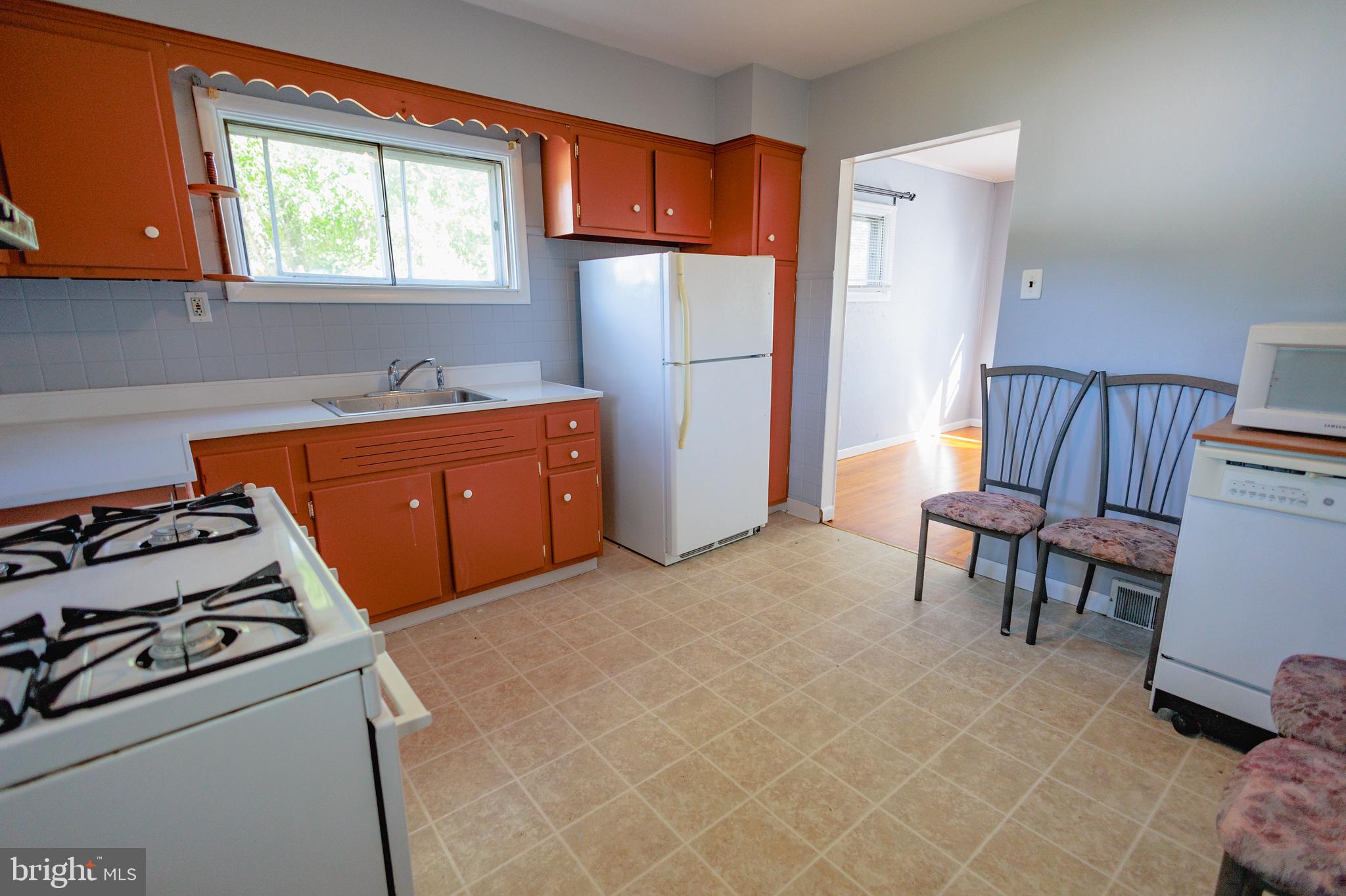 200 Baldwin Road Glassboro, NJ 08028 - Photo 9 of 29 a kitchen with sink a refrigerator and a stove top oven