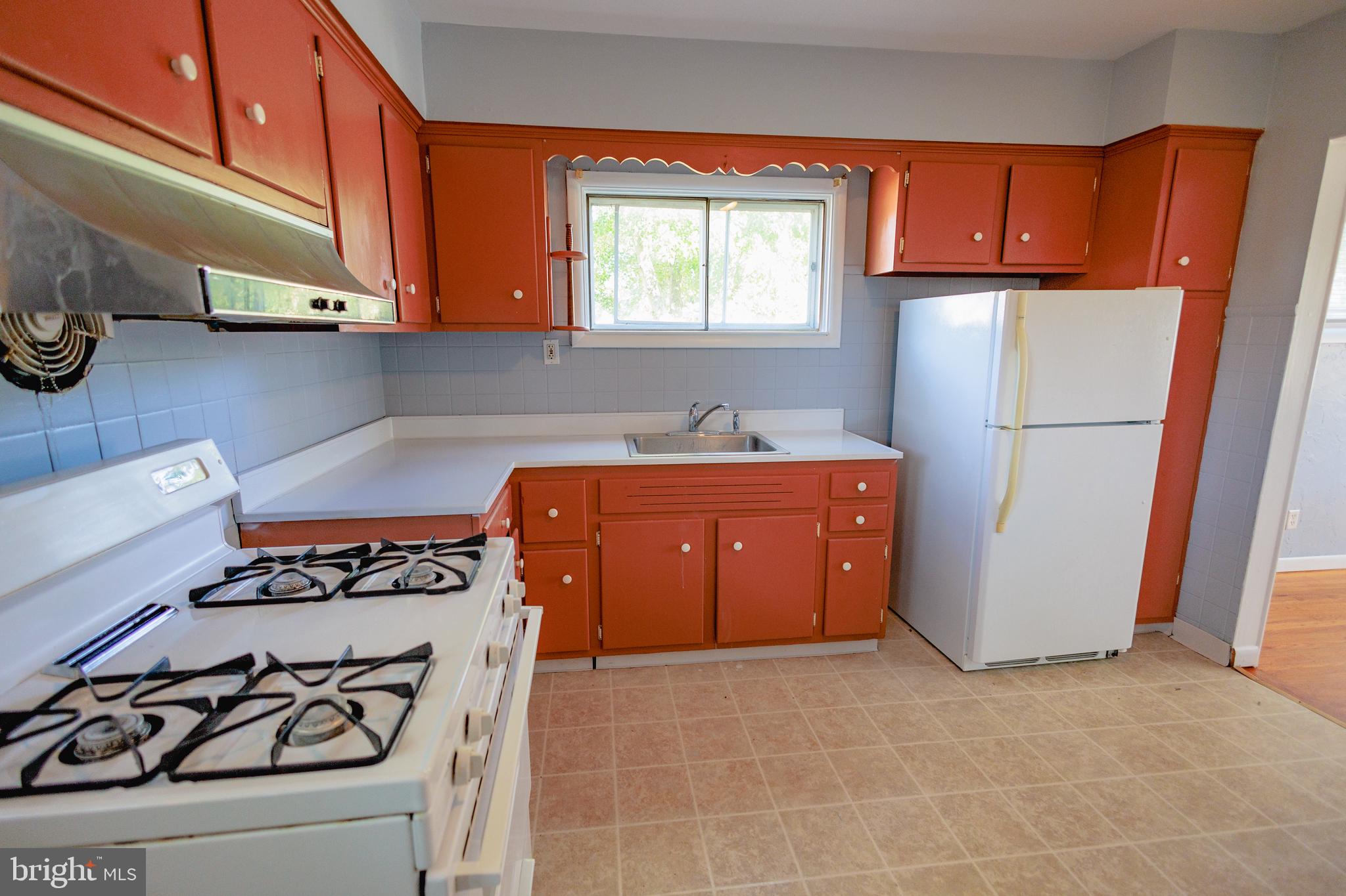 200 Baldwin Road Glassboro, NJ 08028 - Photo 10 of 29 a kitchen with a refrigerator and a stove