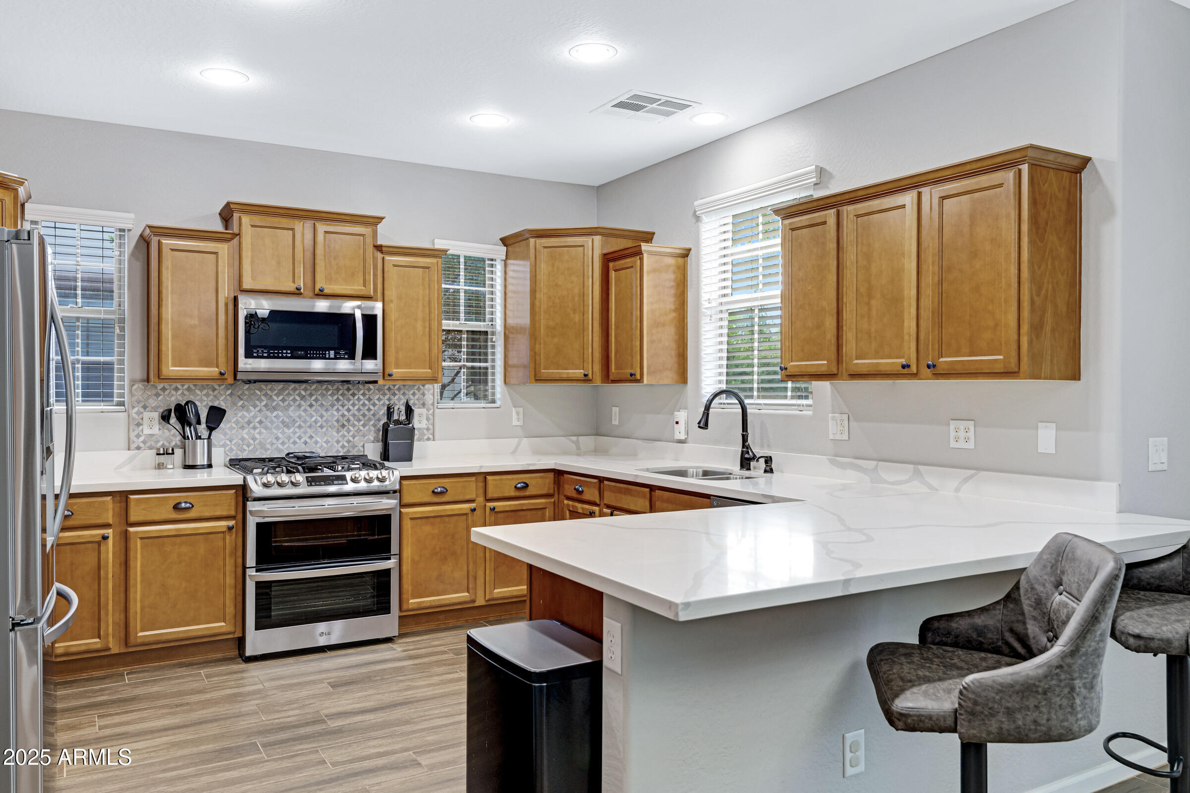 15366 West Bloomfield Road Surprise, AZ 85379 - Photo 11 of 48 a kitchen with stainless steel appliances a stove sink and microwave