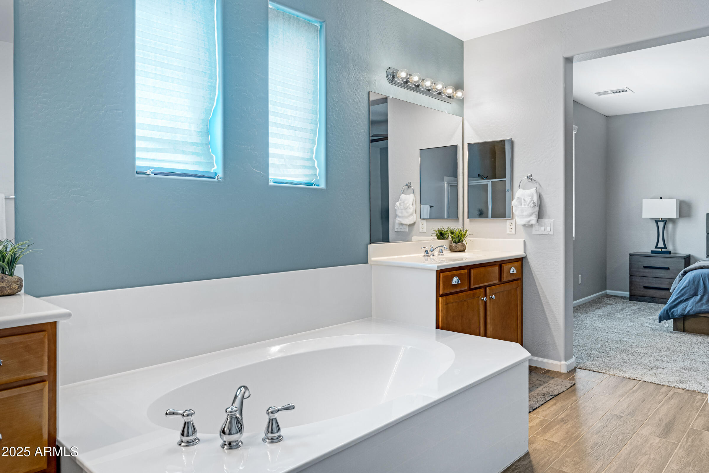 15366 West Bloomfield Road Surprise, AZ 85379 - Photo 14 of 48 a spacious bathroom with a tub double sink and mirror