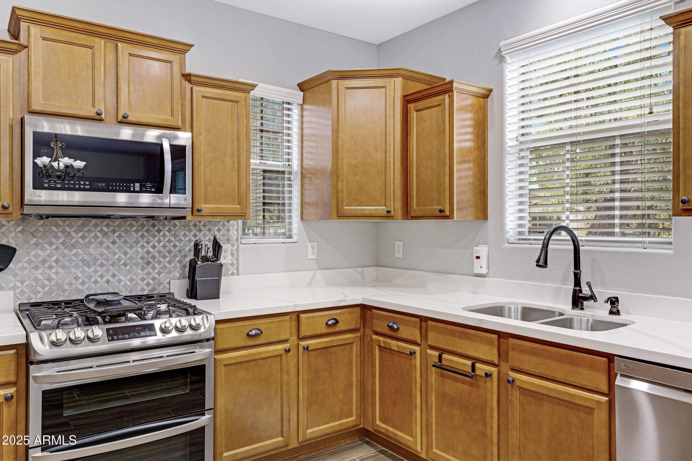 15366 West Bloomfield Road Surprise, AZ 85379 - Photo 26 of 48 a kitchen with stainless steel appliances a stove sink and microwave