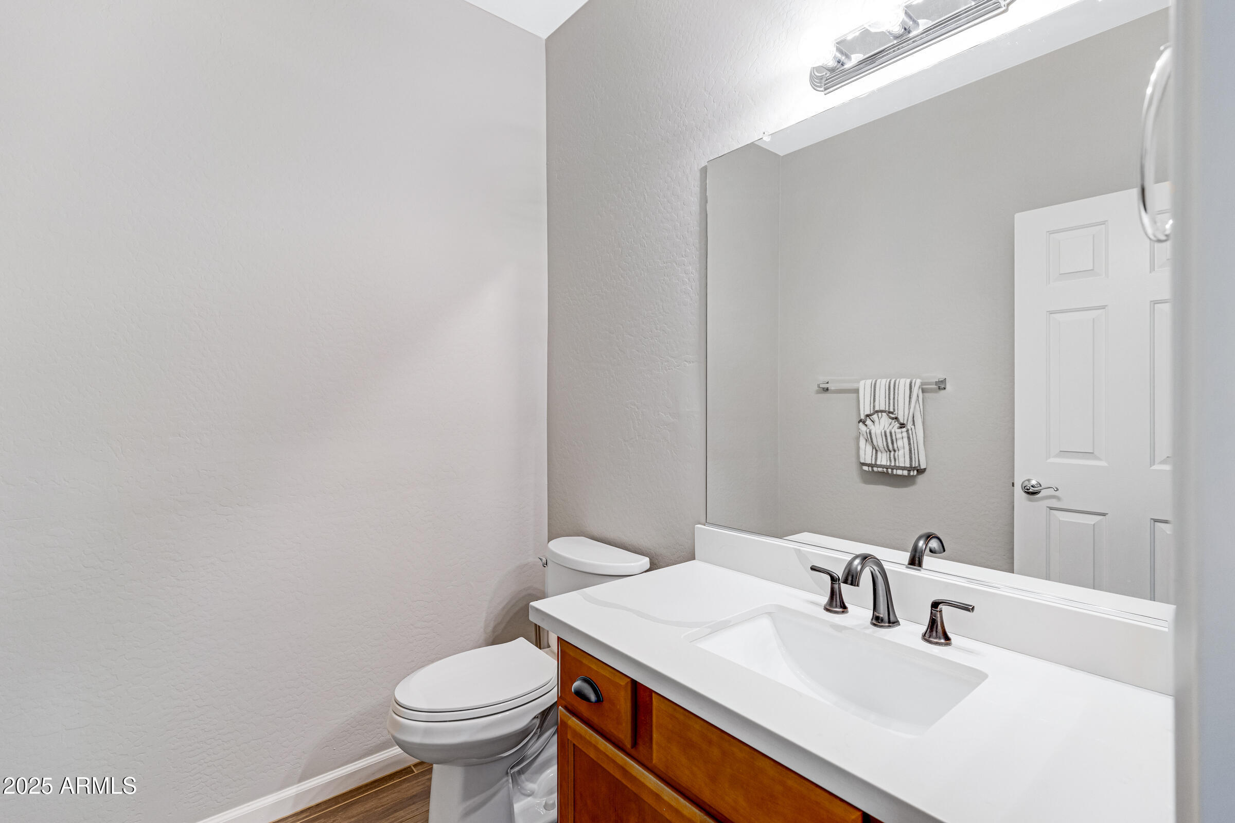 15366 West Bloomfield Road Surprise, AZ 85379 - Photo 27 of 48 a bathroom with a sink a toilet and a mirror