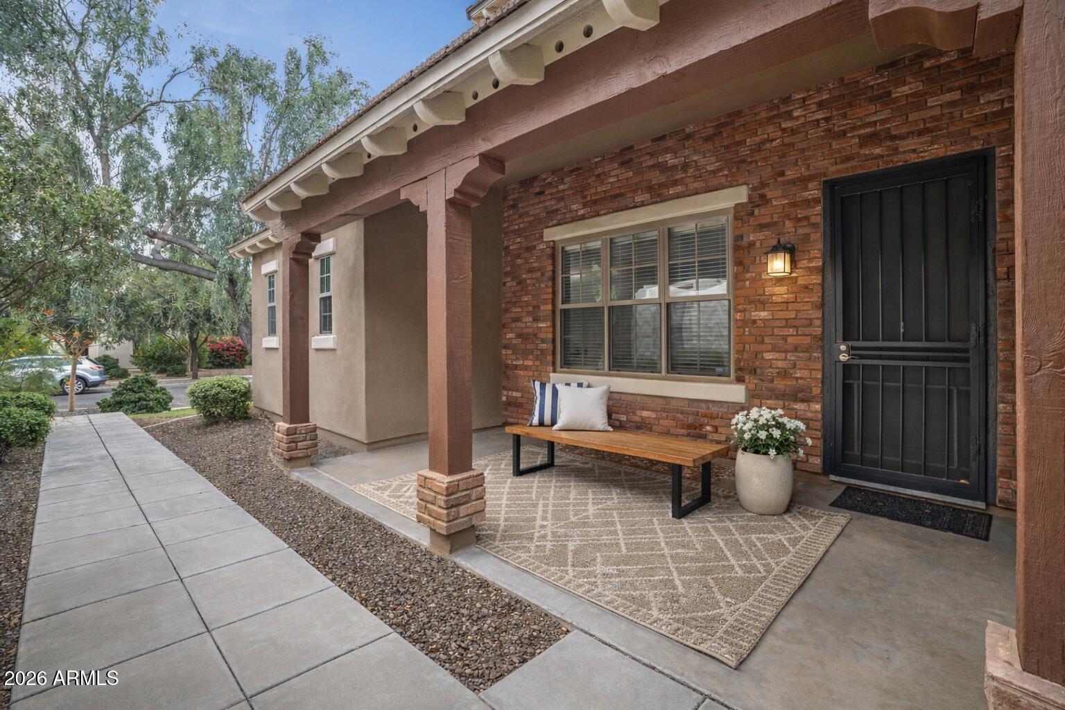 15366 West Bloomfield Road Surprise, AZ 85379 - Photo 3 of 48 a view of a patio with a table and chairs and potted plants