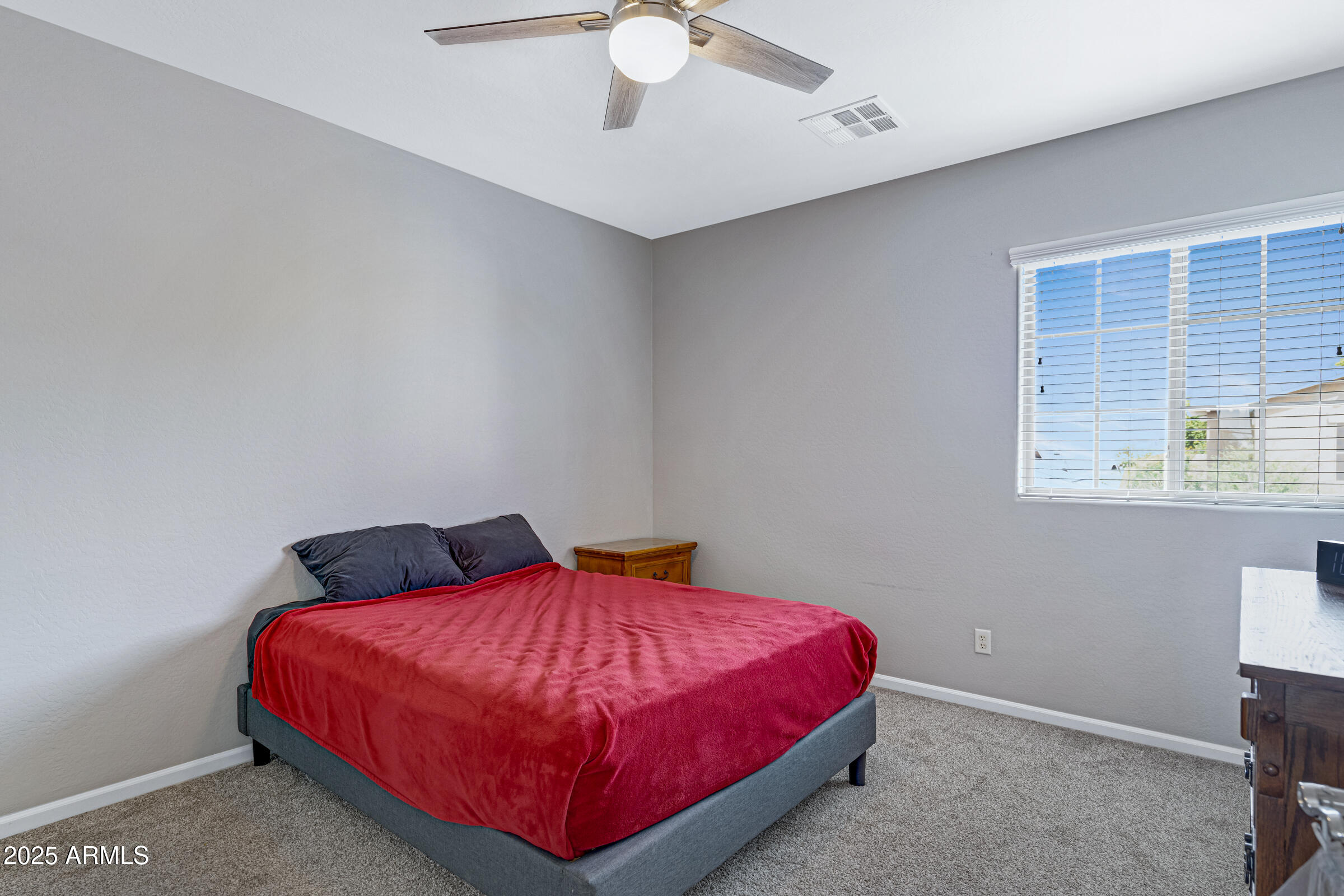 15366 West Bloomfield Road Surprise, AZ 85379 - Photo 36 of 48 a bed sitting in a bedroom next to a window
