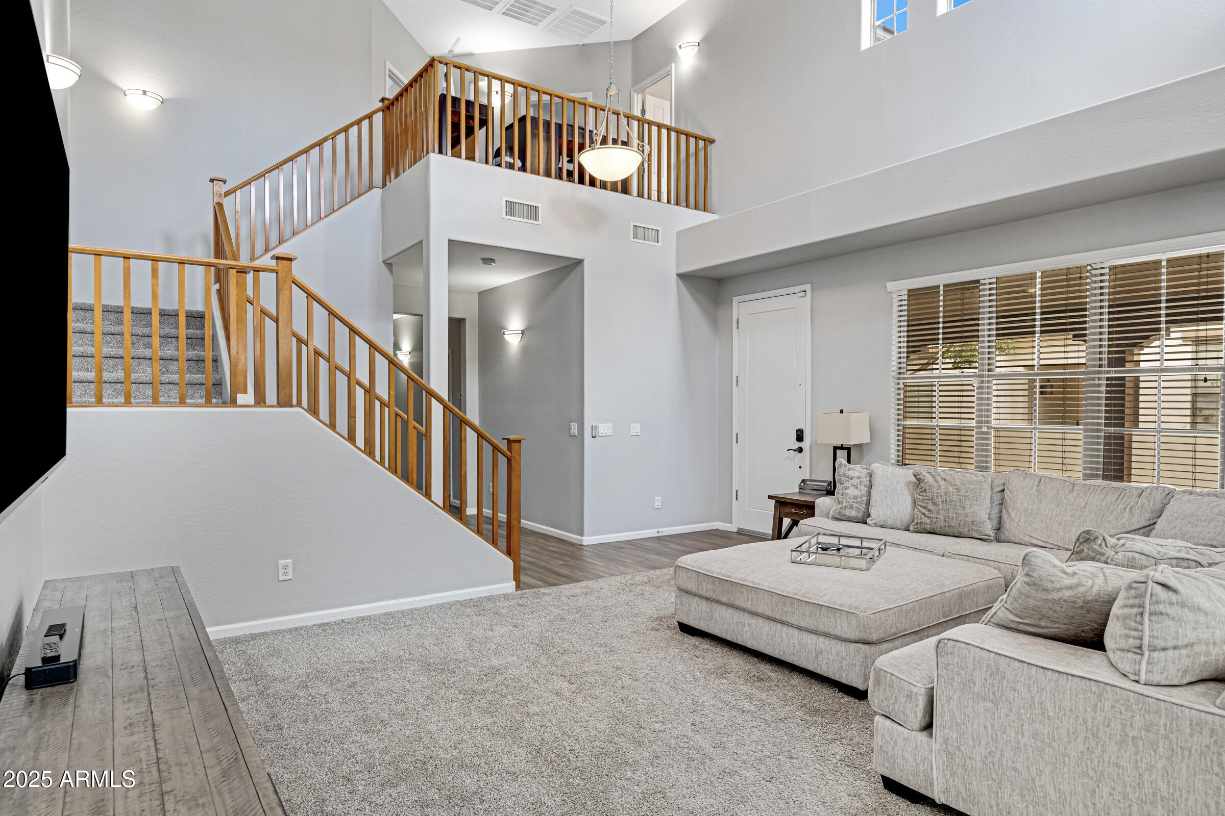 15366 West Bloomfield Road Surprise, AZ 85379 - Photo 5 of 48 a living room with furniture and stairs