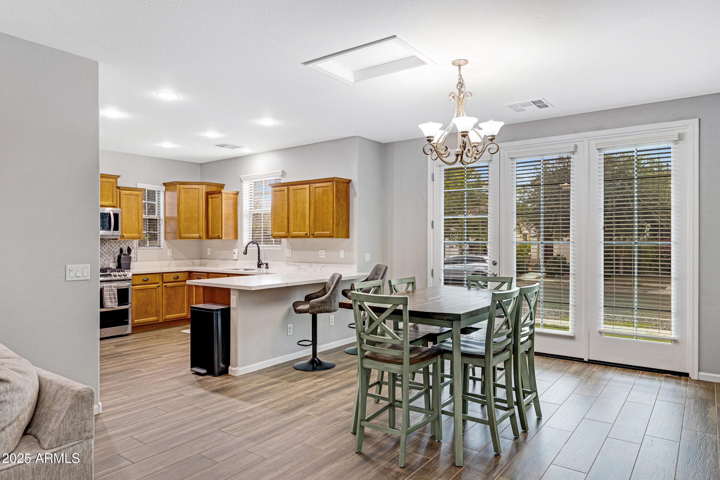15366 West Bloomfield Road Surprise, AZ 85379 - Photo 10 of 48 a view of a dining room with furniture window and wooden floor