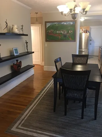 a dining room with furniture and wooden floor