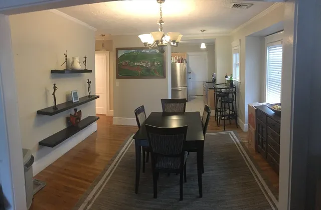 a dining room with furniture and window
