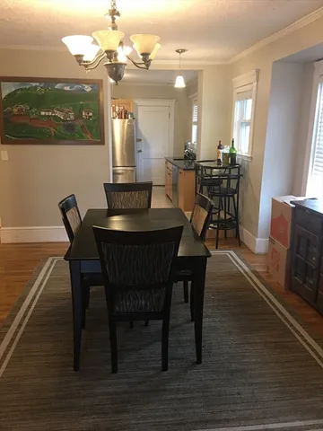 a dining room with furniture and chandelier