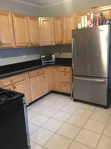 a kitchen with a refrigerator a stove and a cabinets