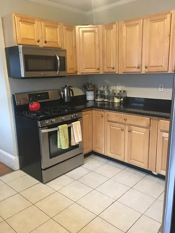 a kitchen with stainless steel appliances a stove a microwave a sink and cabinets