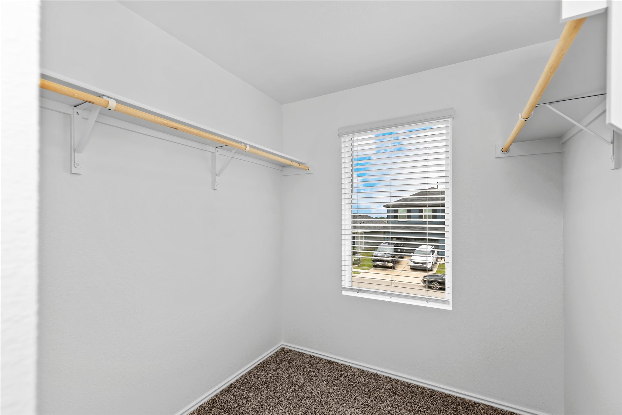 456 Sandringham Loop Kyle, TX 78640 - Photo 20 of 40 Ample closet space with practical shelving and a bright window for natural light.