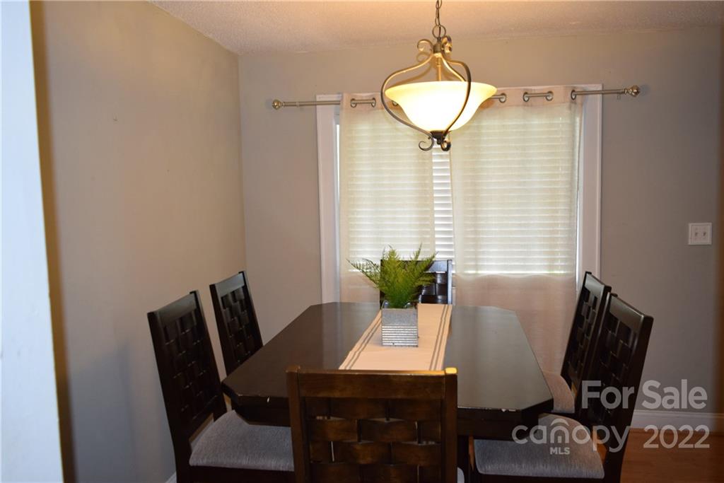 3136 Pea Ridge Road Mill Spring, NC 28756 - Photo 11 of 24 a view of a dining room with furniture and wooden floor