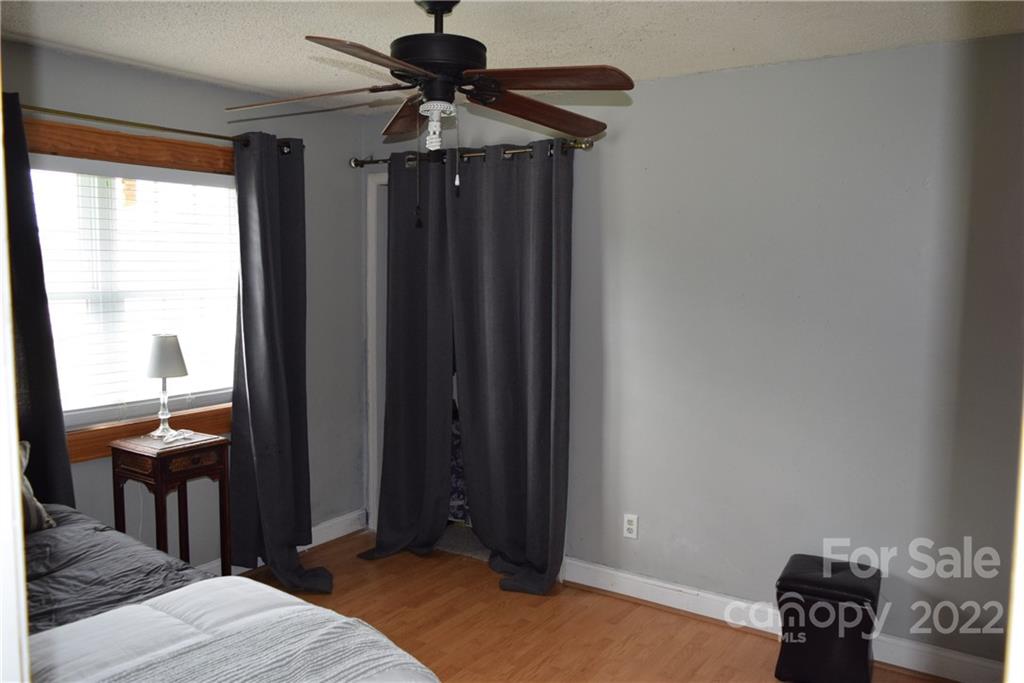 3136 Pea Ridge Road Mill Spring, NC 28756 - Photo 14 of 24 a bedroom with a bed and a window