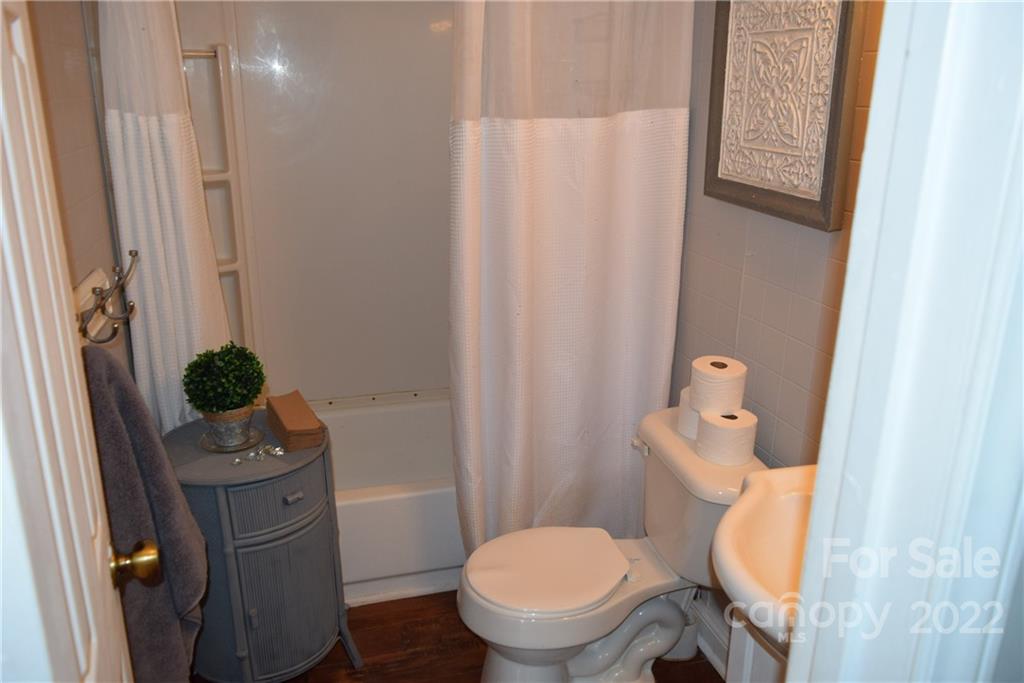 3136 Pea Ridge Road Mill Spring, NC 28756 - Photo 16 of 24 a bathroom with a toilet and a sink