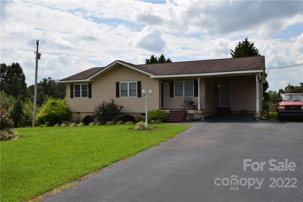 3136 Pea Ridge Road Mill Spring, NC 28756 - Photo 2 of 24 a view of a house with a yard