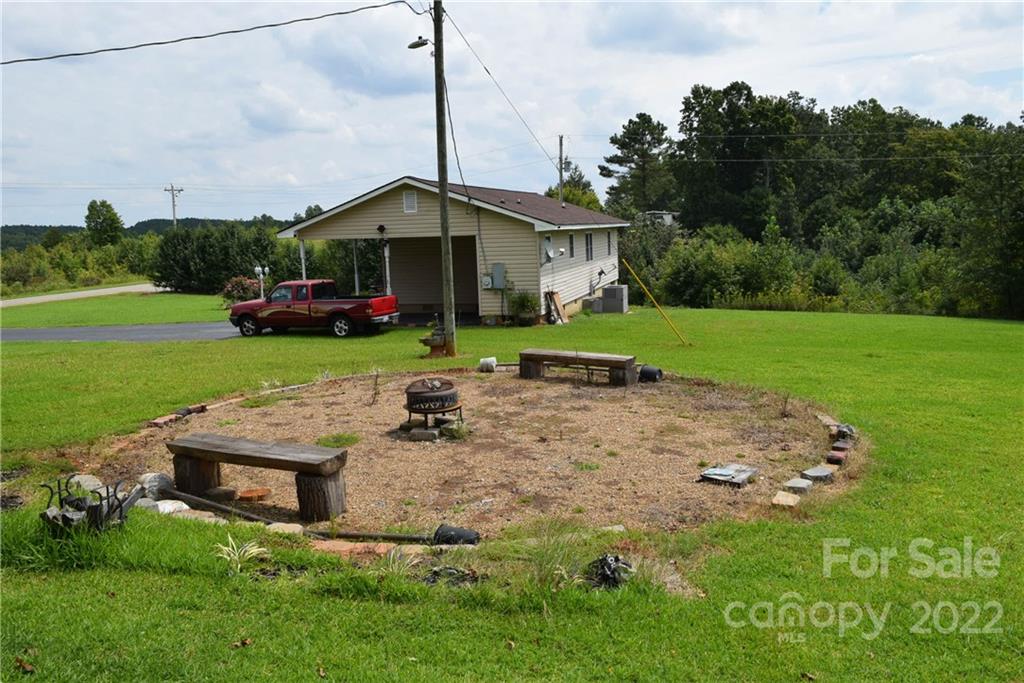3136 Pea Ridge Road Mill Spring, NC 28756 - Photo 23 of 24 a front view of a house with garden