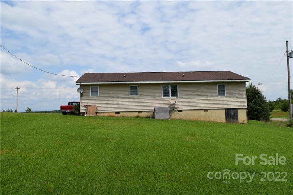 3136 Pea Ridge Road Mill Spring, NC 28756 - Photo 24 of 24 a front view of a house with a garden