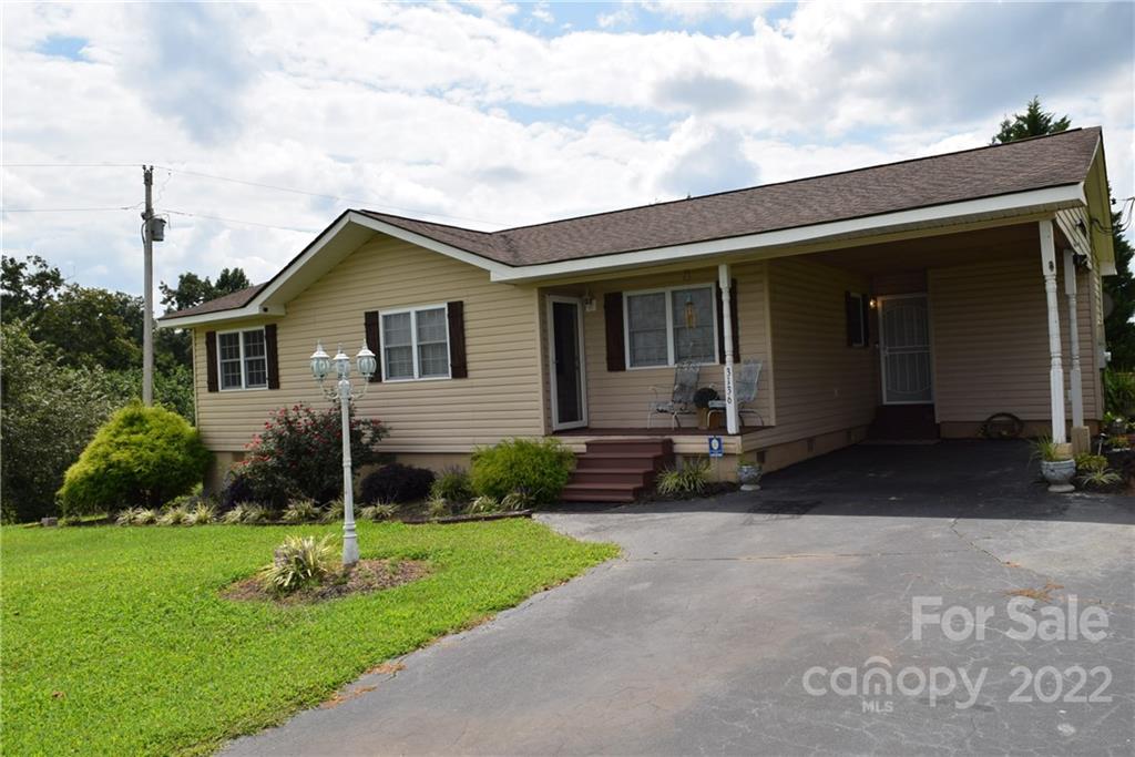 3136 Pea Ridge Road Mill Spring, NC 28756 - Photo 3 of 24 a view of a house with backyard and garden