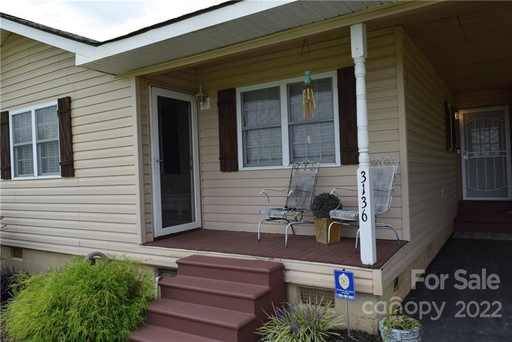 3136 Pea Ridge Road Mill Spring, NC 28756 - Photo 4 of 24 a front view of a house with a porch