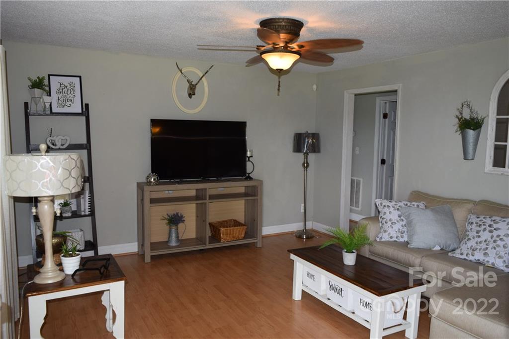 3136 Pea Ridge Road Mill Spring, NC 28756 - Photo 6 of 24 a living room with furniture and a flat screen tv