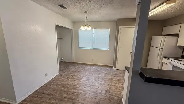 a view of a refrigerator in kitchen and wooden floor