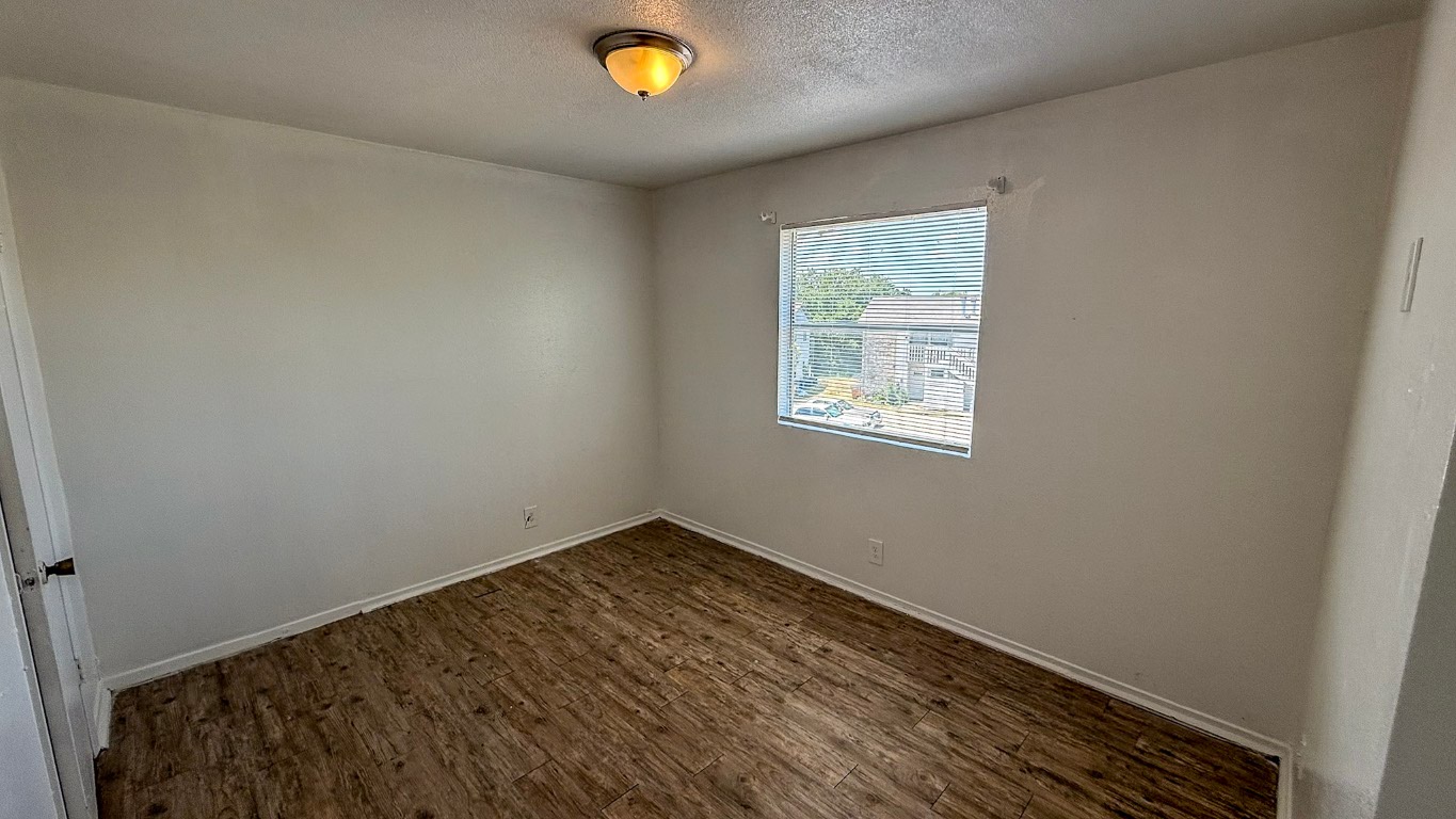 501 Hardin Court, Unit D Austin, TX 78753 - Photo 7 of 13 a view of a room with wooden floor and window