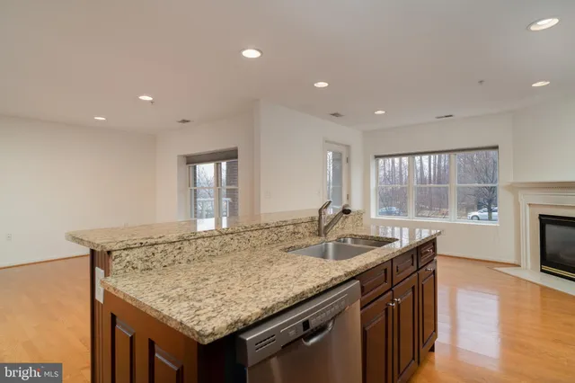 a kitchen with granite countertop kitchen island a sink and a stove