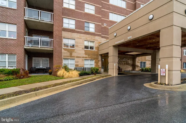 a front view of a building with a garden
