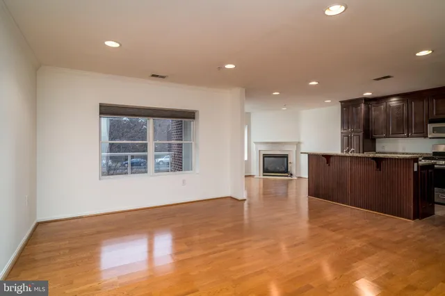 a view of kitchen with granite countertop cabinets and wooden floor