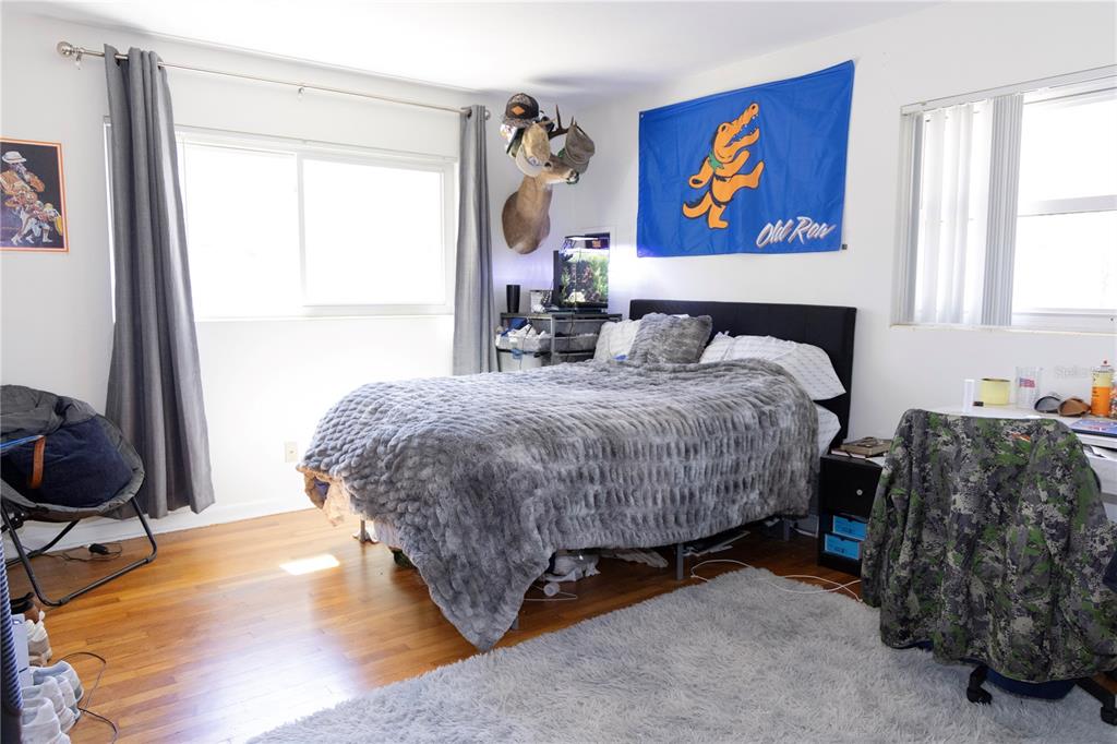 2910 Southwest 1st Avenue Gainesville, FL 32607 - Photo 11 of 16 a bed sitting in a bedroom next to a window