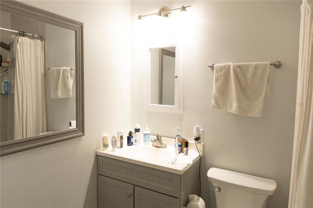 2910 Southwest 1st Avenue Gainesville, FL 32607 - Photo 14 of 16 a bathroom with 2 sink toilet and a mirror