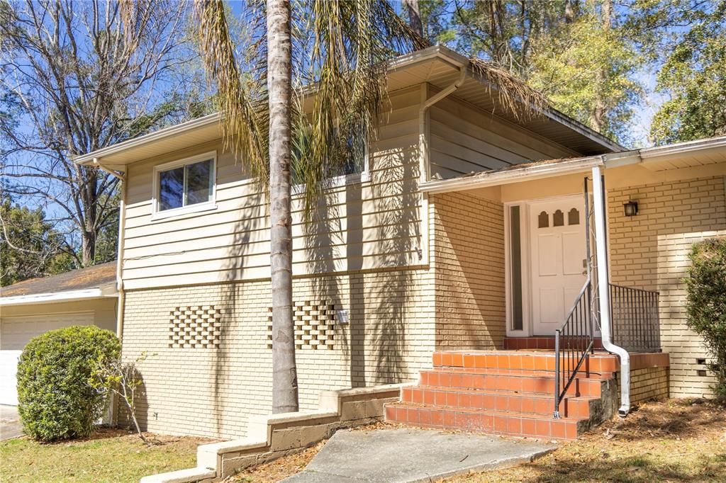 2910 Southwest 1st Avenue Gainesville, FL 32607 - Photo 2 of 16 a front view of a house with a yard