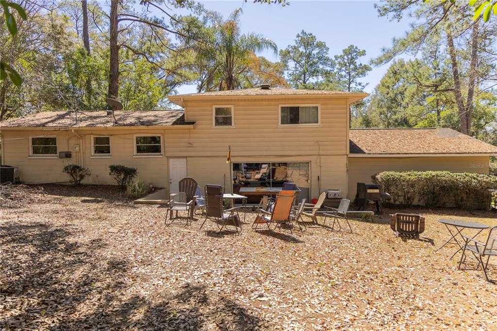 2910 Southwest 1st Avenue Gainesville, FL 32607 - Photo 4 of 16 a view of a backyard with a table and chairs