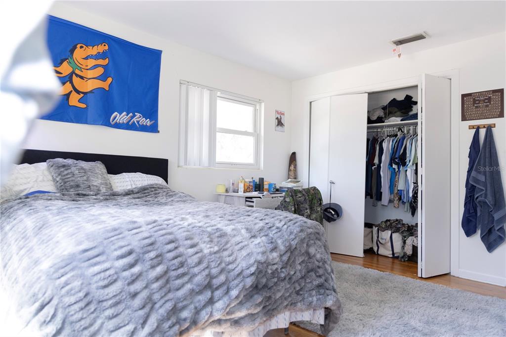 2910 Southwest 1st Avenue Gainesville, FL 32607 - Photo 8 of 16 a bedroom with a bed and a window