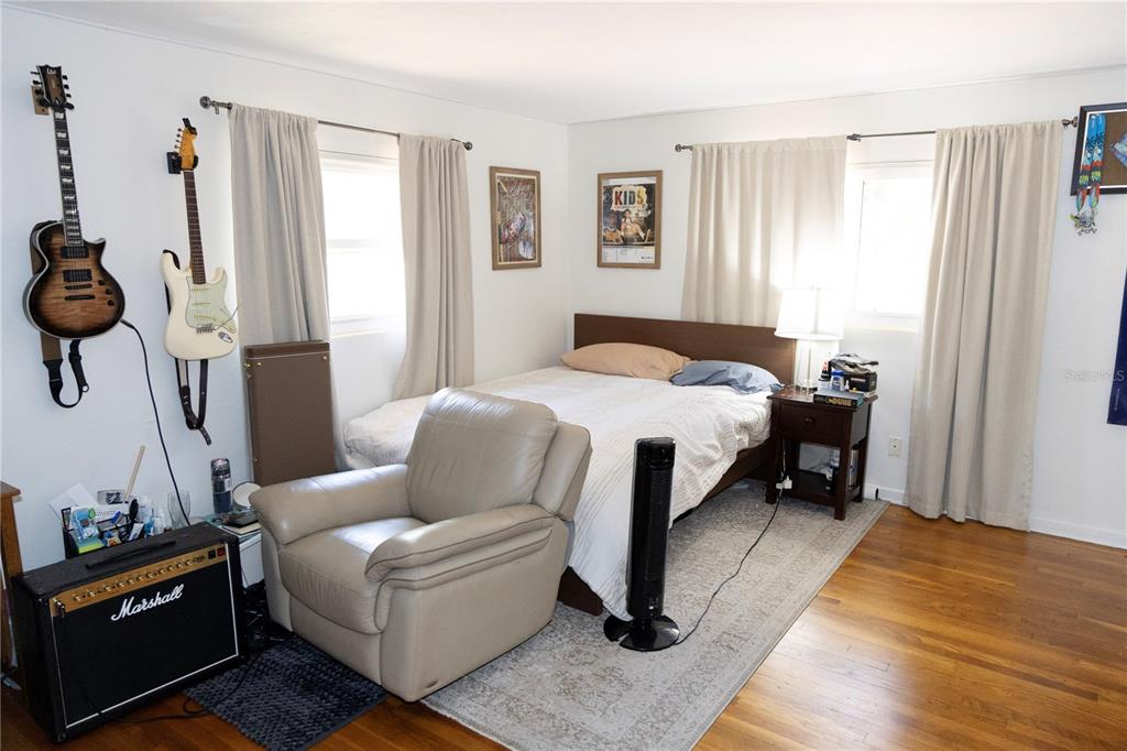 2910 Southwest 1st Avenue Gainesville, FL 32607 - Photo 9 of 16 a bedroom with a bed and wooden floor