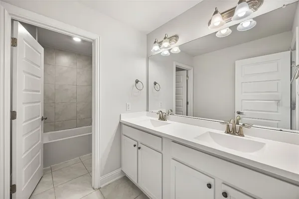 a bathroom with a sink a tub and a mirror