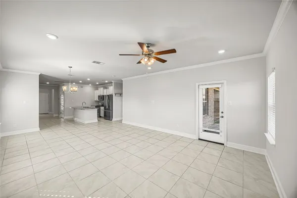 a view of an empty room with a ceiling fan