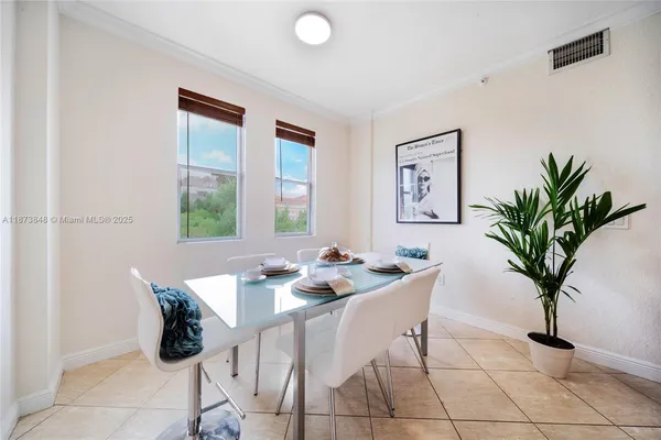 a dining room with furniture and window