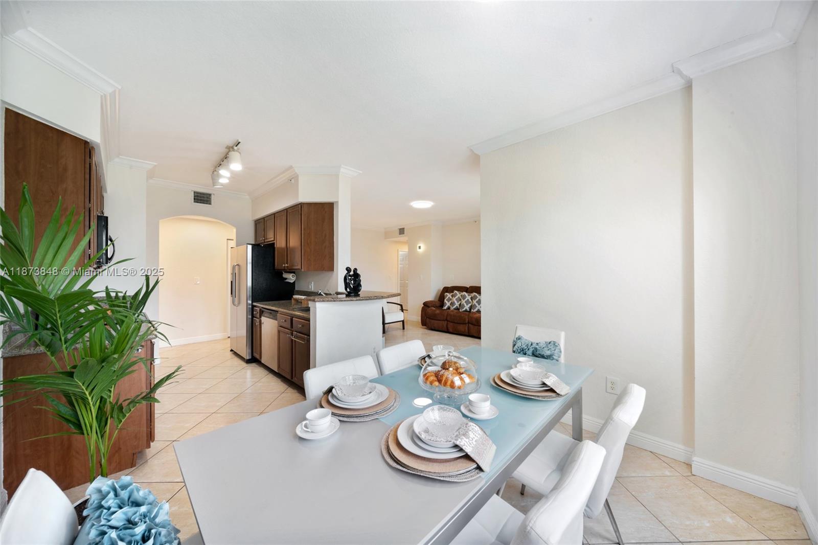 9021 Southwest 94th Street, Unit 310 Miami, FL 33176 - Photo 13 of 41 a living room with furniture kitchen and a potted plant