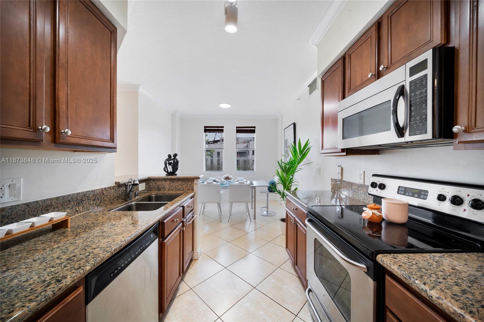 9021 Southwest 94th Street, Unit 310 Miami, FL 33176 - Photo 15 of 41 a kitchen with stainless steel appliances granite countertop a sink stove and cabinets