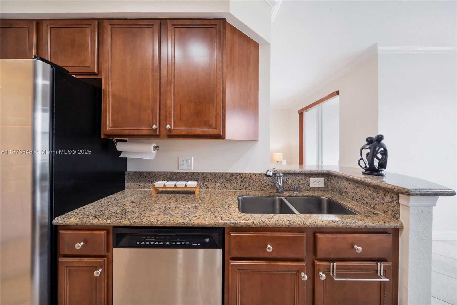 9021 Southwest 94th Street, Unit 310 Miami, FL 33176 - Photo 17 of 41 a kitchen with granite countertop a refrigerator and a sink