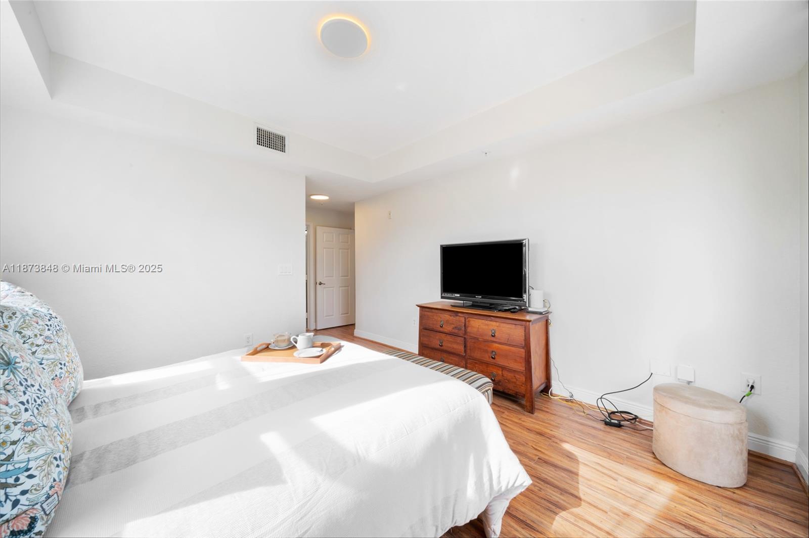 9021 Southwest 94th Street, Unit 310 Miami, FL 33176 - Photo 20 of 41 a bedroom with a bed and a flat screen tv