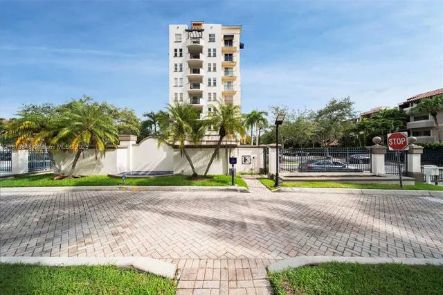 a view of a swimming pool with a yard and plants