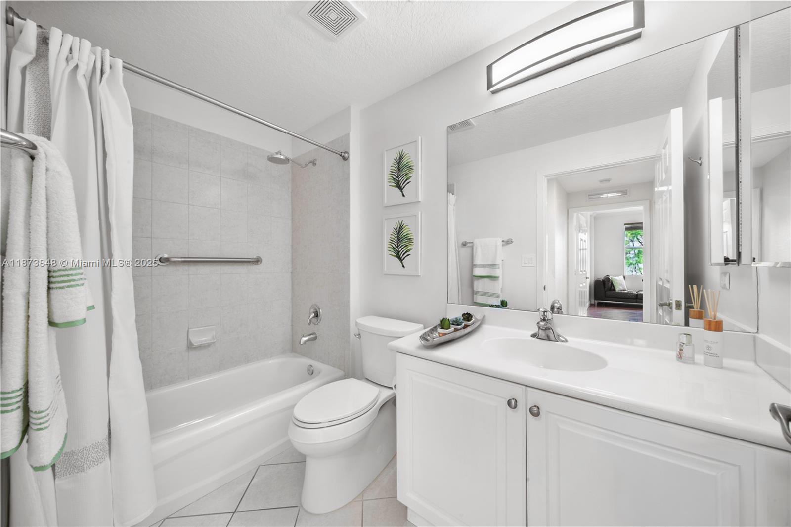 9021 Southwest 94th Street, Unit 310 Miami, FL 33176 - Photo 24 of 41 a bathroom with a double vanity sink toilet mirror and shower