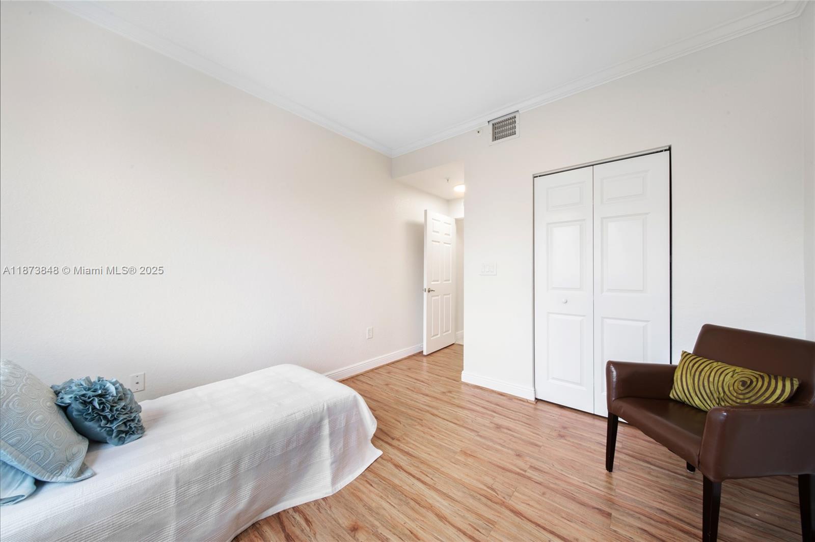 9021 Southwest 94th Street, Unit 310 Miami, FL 33176 - Photo 26 of 41 a bed room with a bed and a chair