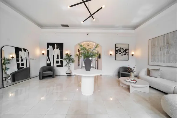 a living room with furniture and a chandelier
