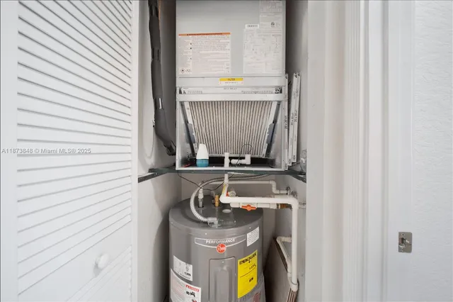 a view of a refrigerator in kitchen and an empty room