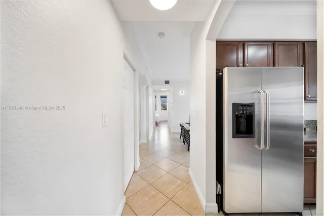 a kitchen with stainless steel appliances granite countertop a refrigerator and a stove