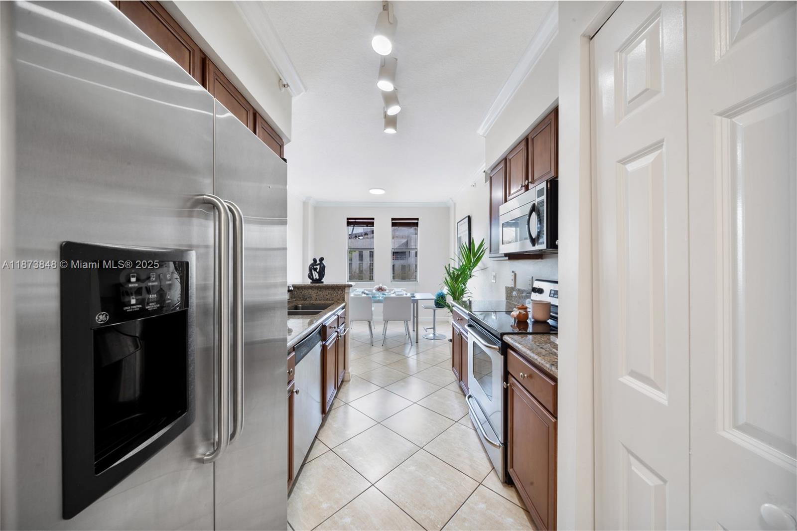 9021 Southwest 94th Street, Unit 310 Miami, FL 33176 - Photo 41 of 41 a kitchen with stainless steel appliances granite countertop a refrigerator and a stove